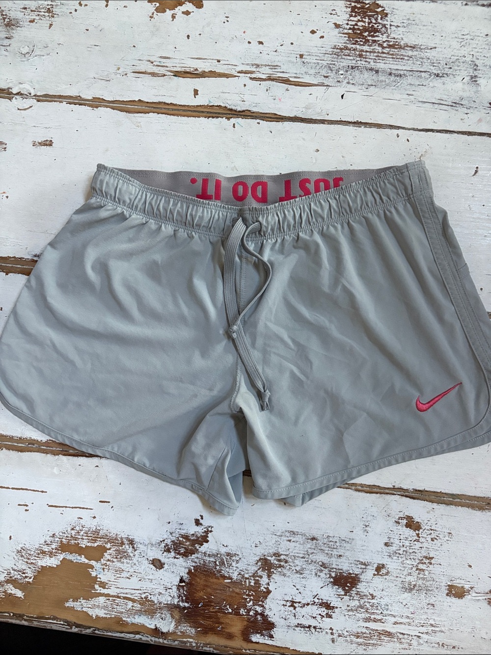 Nike Women’s Light Gray Athletic Shorts with Pink Swoosh